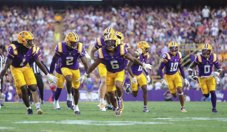 LSU players run onto the field at Tiger Stadium before a game