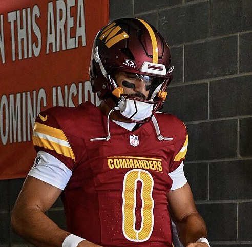 Washington Commanders quarterback Marcus Mariota walks through the tunnel in his No. 0 jersey